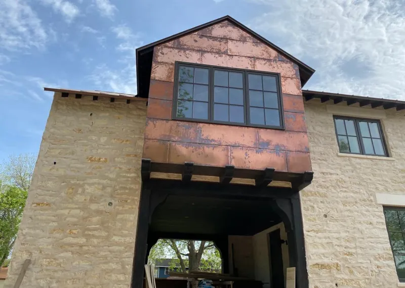 Copper metal panel facade on a stone building for Roof Repair in Hurricane